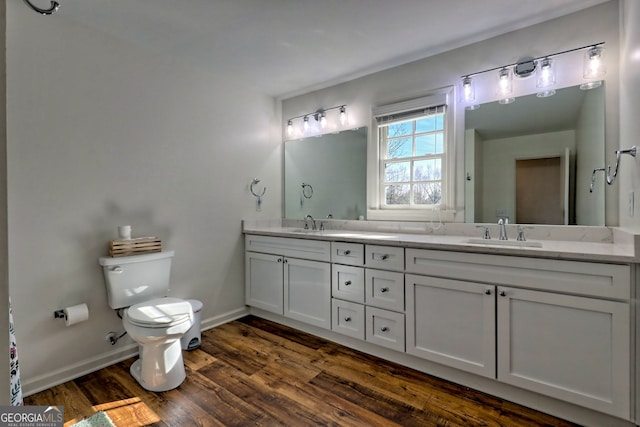 bathroom with toilet, vanity, and hardwood / wood-style flooring