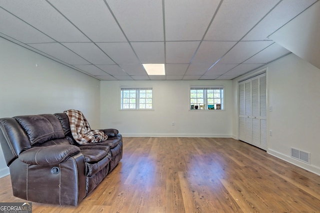 interior space with wood-type flooring and a drop ceiling