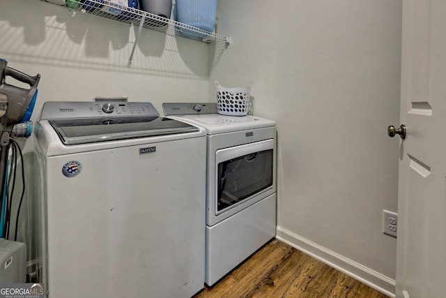 laundry area featuring dark hardwood / wood-style flooring and washing machine and clothes dryer