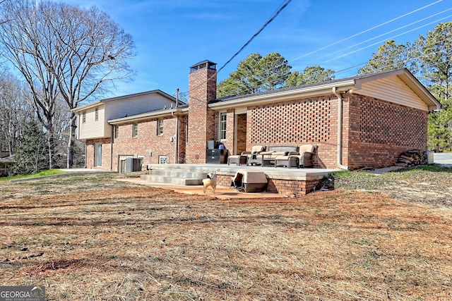 rear view of house with central AC and a patio area