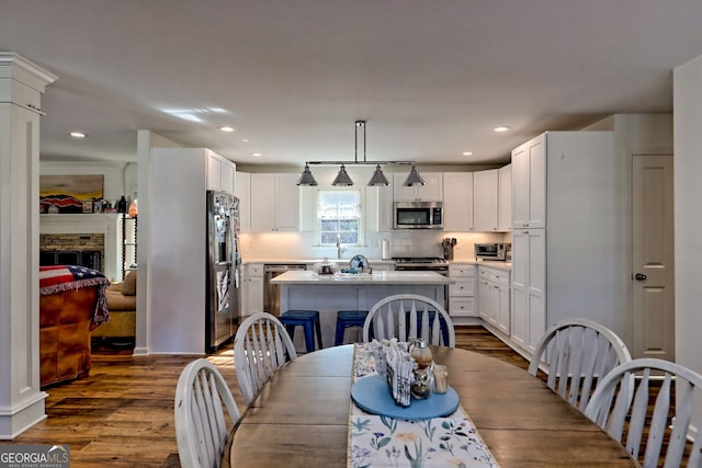 dining space with dark hardwood / wood-style flooring