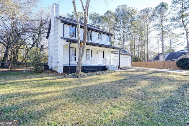 view of property with a porch, a garage, and a front yard