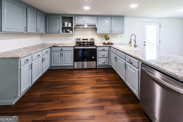 kitchen with sink, gray cabinetry, stainless steel appliances, dark hardwood / wood-style floors, and light stone countertops