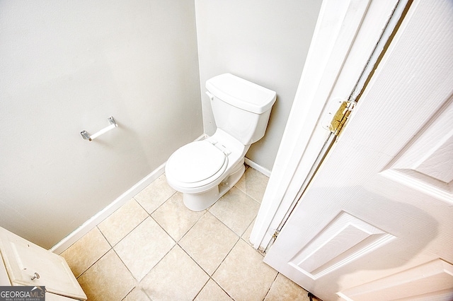 bathroom featuring toilet and tile patterned flooring