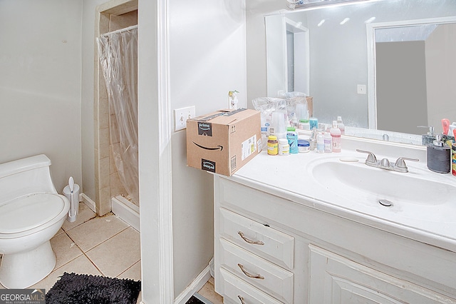 bathroom with toilet, tile patterned flooring, curtained shower, and vanity