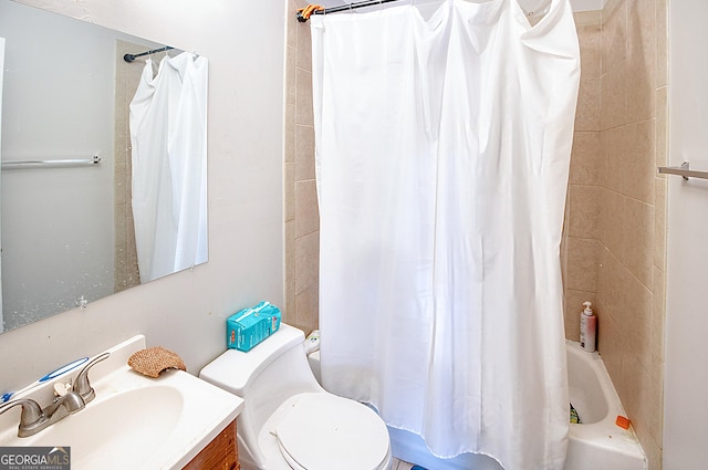 full bathroom with shower / tub combo with curtain, vanity, and toilet