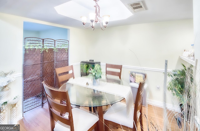 dining area featuring a notable chandelier and wood-type flooring