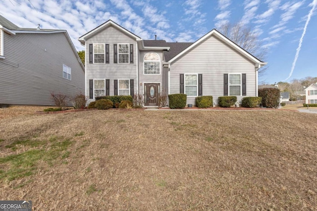 front facade featuring a front yard