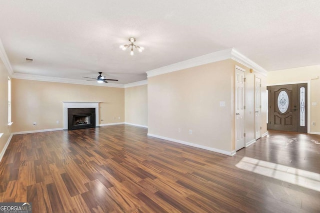 unfurnished living room with ornamental molding, ceiling fan, and dark hardwood / wood-style floors