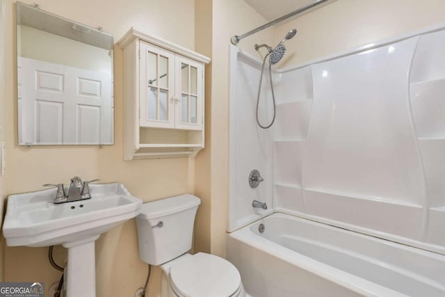 bathroom with tub / shower combination and toilet