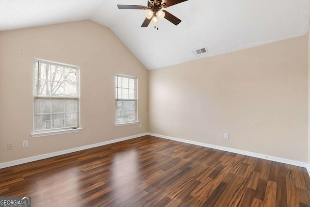 unfurnished room with ceiling fan, vaulted ceiling, and dark hardwood / wood-style floors