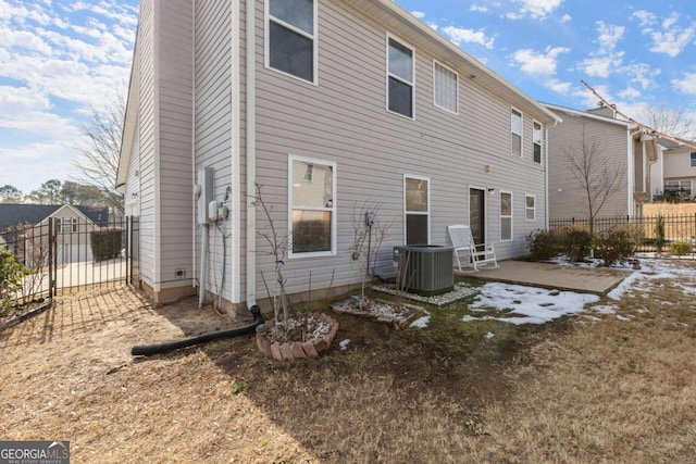 back of property with a patio area and central air condition unit