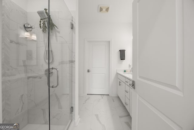 bathroom featuring vanity and an enclosed shower