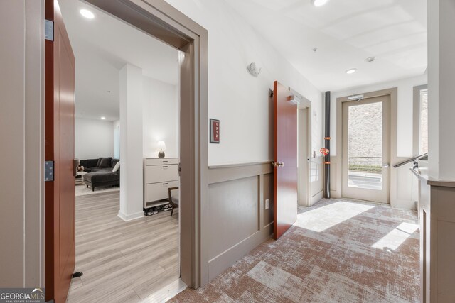 bathroom with hardwood / wood-style floors and elevator