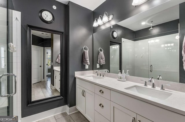 bathroom featuring tile patterned flooring, vanity, and a shower with door