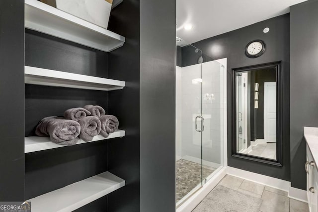 bathroom featuring tile patterned flooring, vanity, and a shower with shower door