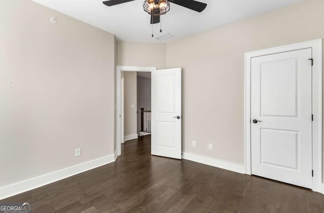 unfurnished bedroom featuring dark hardwood / wood-style flooring and ceiling fan