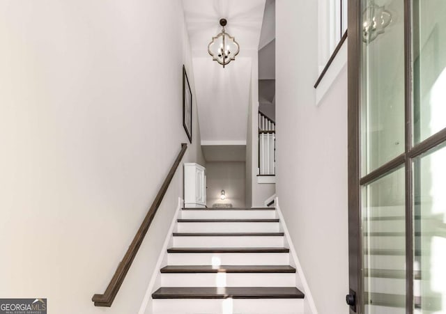 stairs with an inviting chandelier