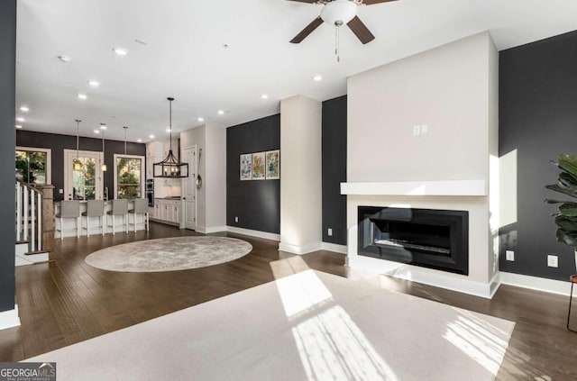 living room featuring dark hardwood / wood-style floors and ceiling fan