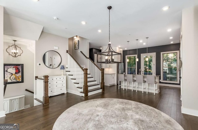 dining area with dark hardwood / wood-style flooring and a notable chandelier