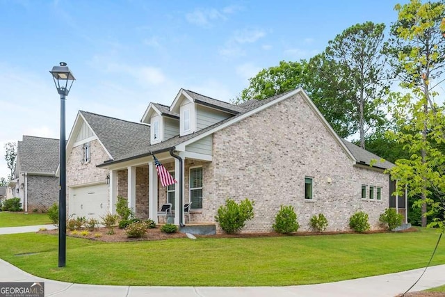 view of front of home with a porch, a front yard, and a garage