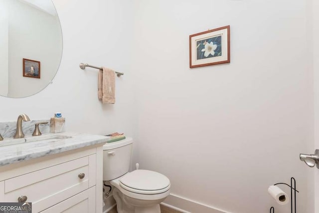 bathroom featuring toilet and vanity