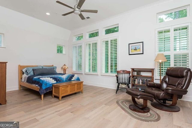 bedroom featuring ornamental molding, ceiling fan, and light hardwood / wood-style flooring