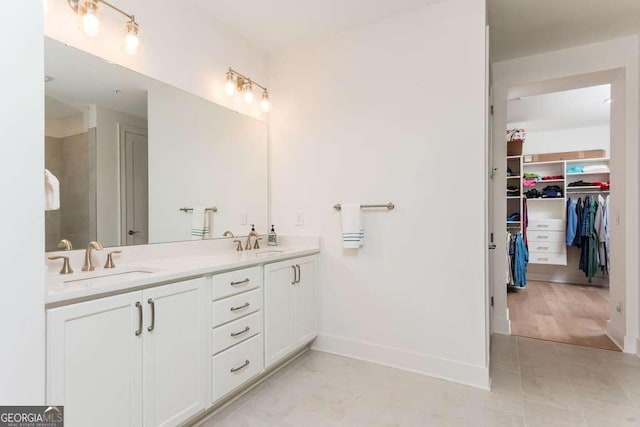 bathroom with tile patterned floors and vanity