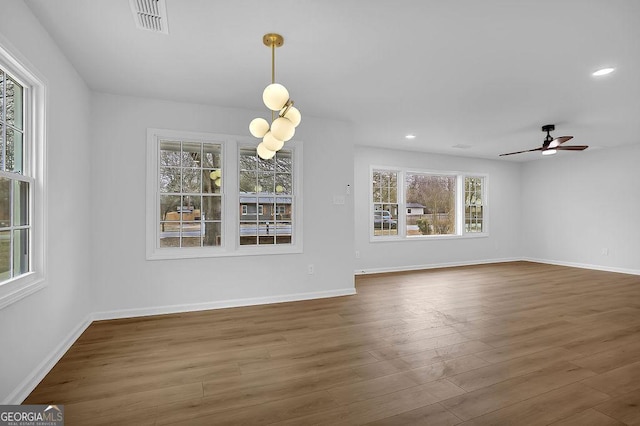 unfurnished dining area with baseboards, visible vents, dark wood finished floors, and recessed lighting