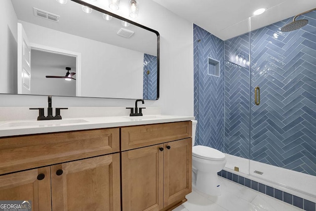 bathroom with visible vents, a sink, toilet, and double vanity