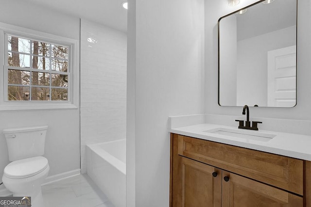 full bathroom with toilet, vanity, baseboards, marble finish floor, and washtub / shower combination