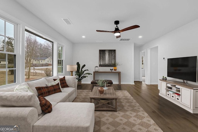 living room featuring dark wood-style floors, recessed lighting, and visible vents