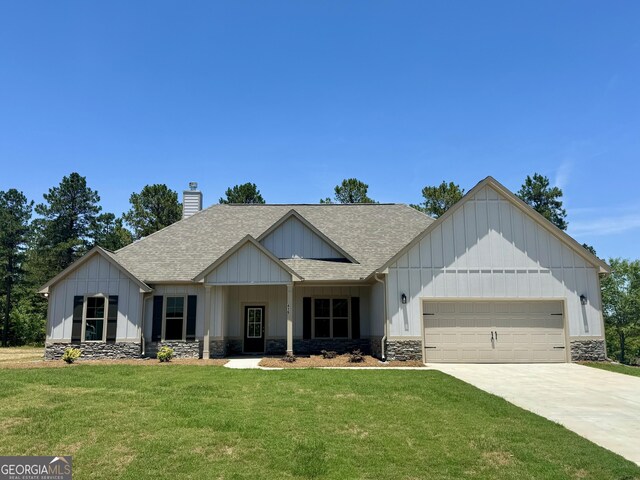 view of front of property featuring a garage and a front lawn