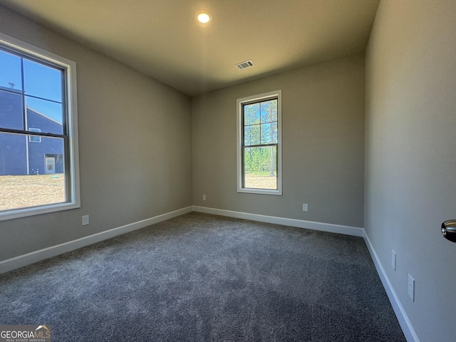 empty room featuring dark colored carpet