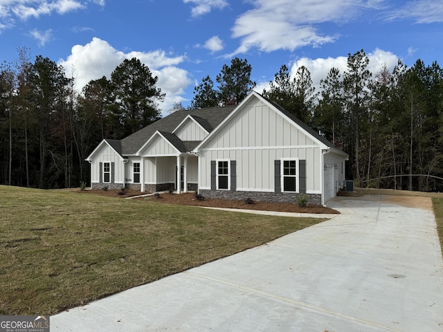 modern inspired farmhouse with a garage and a front lawn