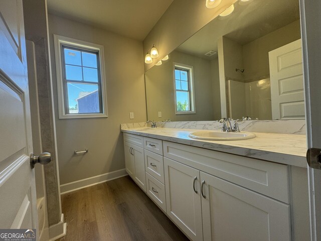 bathroom featuring vanity, hardwood / wood-style floors, and walk in shower