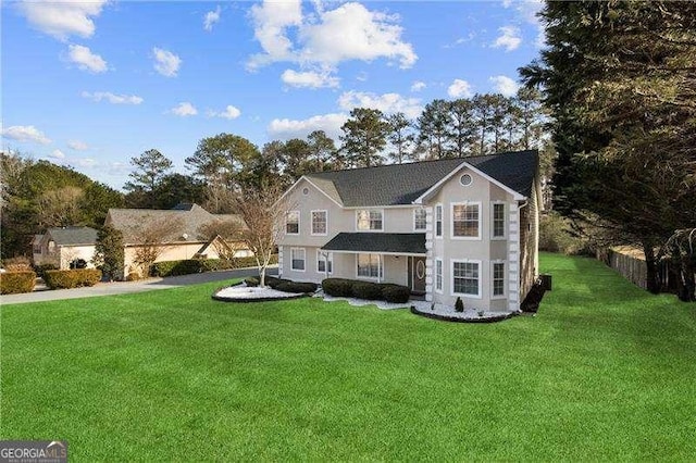 view of property featuring a front lawn