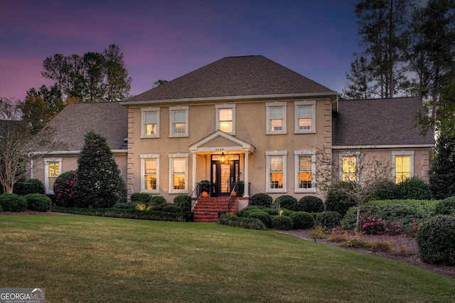 colonial home with a lawn