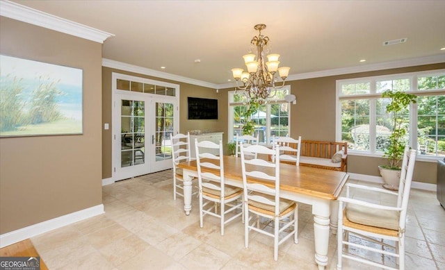 dining space with french doors, a chandelier, and ornamental molding