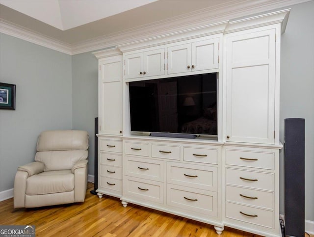 sitting room featuring ornamental molding and light hardwood / wood-style floors