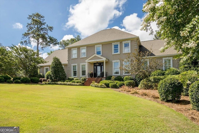 colonial house featuring a front yard