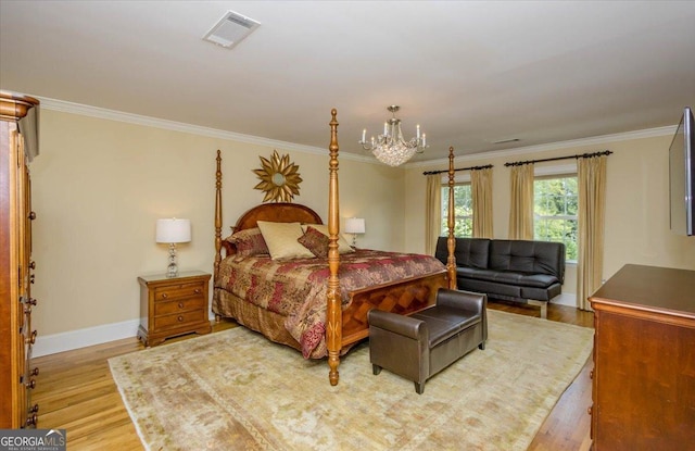 bedroom featuring light wood-type flooring, crown molding, and a chandelier