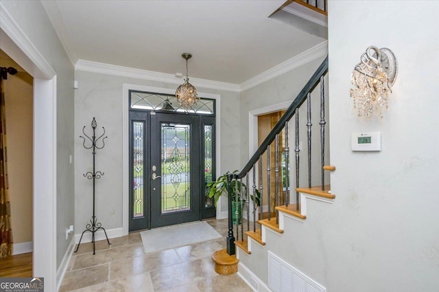 entryway with an inviting chandelier and ornamental molding