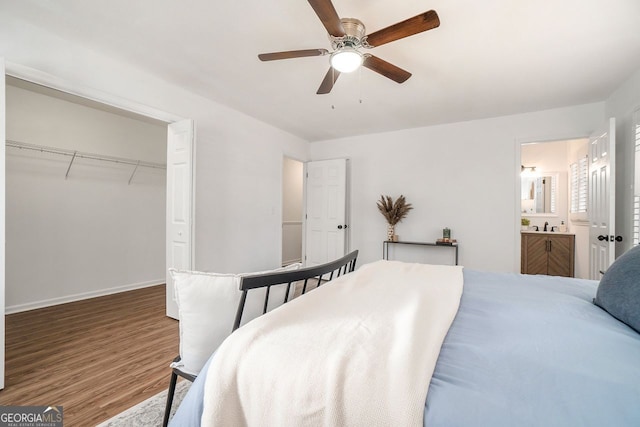 bedroom with hardwood / wood-style floors, a closet, ensuite bath, and ceiling fan