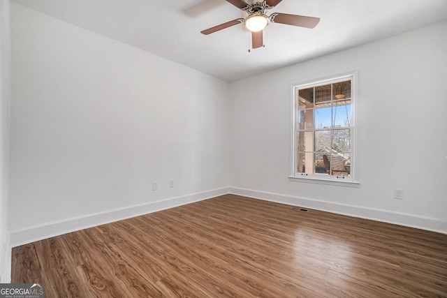 unfurnished room with ceiling fan and wood-type flooring