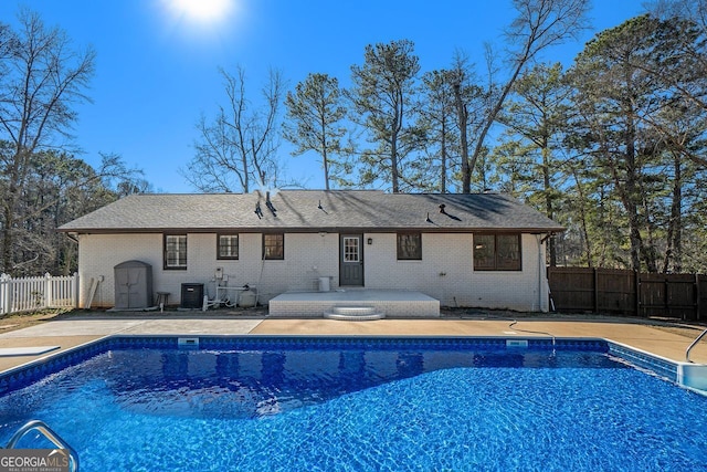 view of pool with a patio and central air condition unit