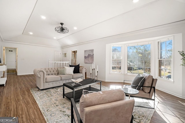 living room with hardwood / wood-style flooring and vaulted ceiling