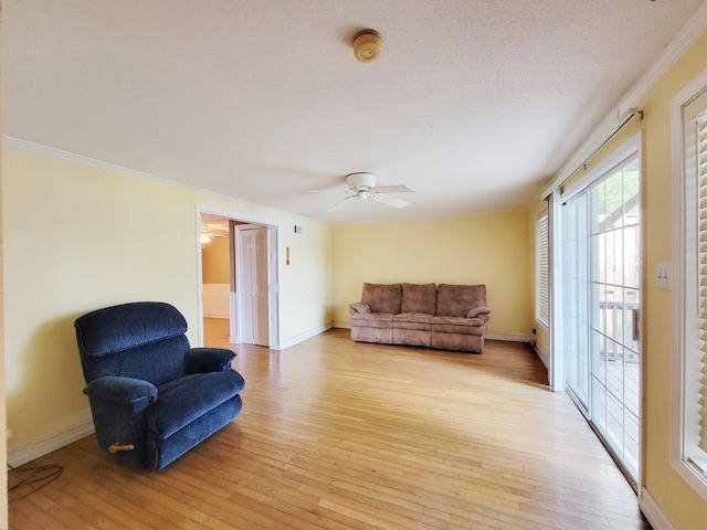 living room with ceiling fan and light hardwood / wood-style floors