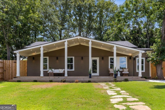 rear view of property featuring a yard