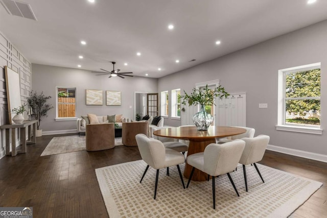 dining space with ceiling fan and dark hardwood / wood-style flooring